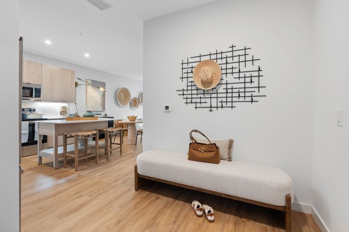 Chic open-concept kitchen and dining area with modern decor and warm wooden accents, perfect for stylish urban living.