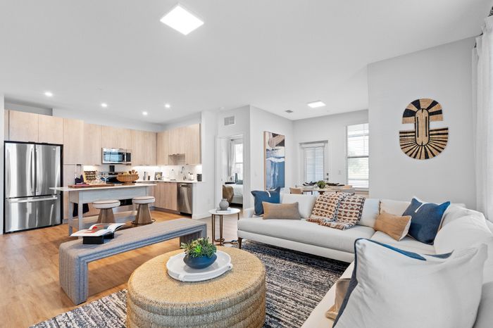 Contemporary open-concept living space with a modern kitchen, stylish decor, and cozy seating area.