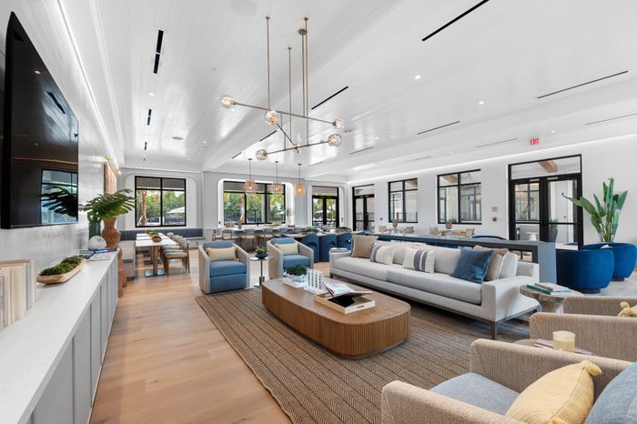 Bright and modern lounge with elegant seating, stylish decor, and ample natural light, perfect for social gatherings.