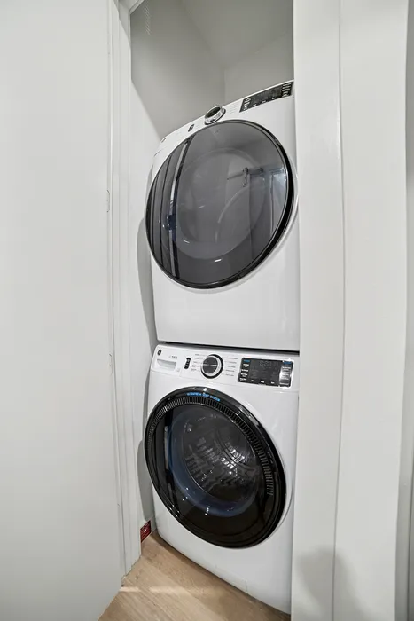 Modern apartment laundry nook with sleek stackable washer and dryer, optimizing space and convenience.