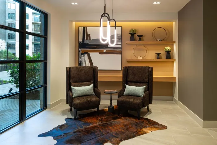 Chic lobby area with modern decor, showcasing elegant seating, artistic wall art, and ambient lighting.