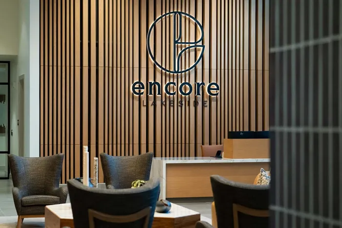 Chic lounge area at Encore Lakeside featuring modern decor and a welcoming reception.