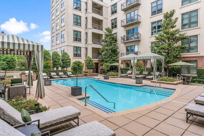 Sophisticated pool deck with cabanas, BBQ grills, chais lounge chairs
