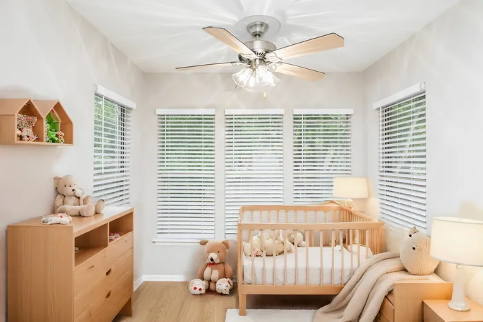 Carpeted Children's Bedroom with Large Windows in an Autumn Columbia apartment.