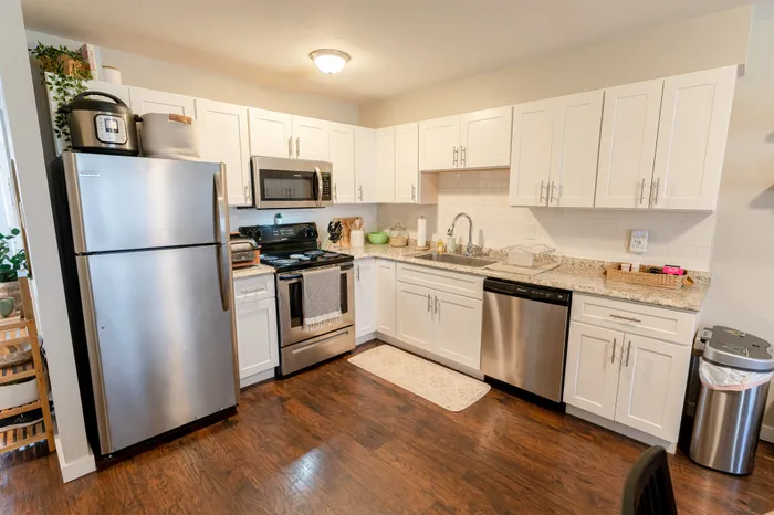 Kitchen featuring stainless steel appliances, white cabinets, and granite countertops in Collegeville, PA.