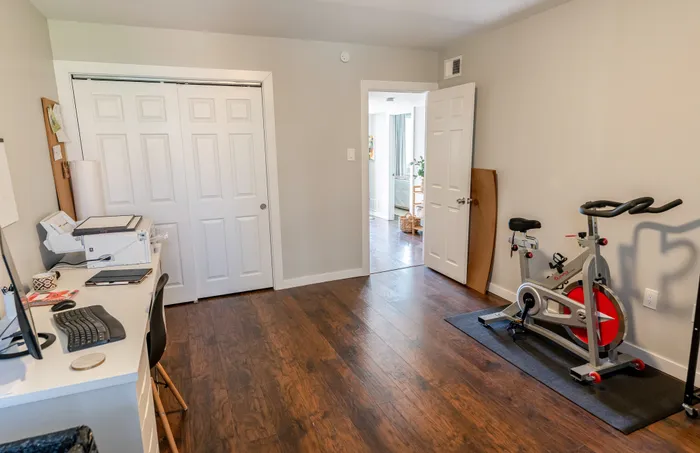Multipurpose room with desk, printer, closet and stationary bike at 405 at Main Apartments in Collegeville, PA.