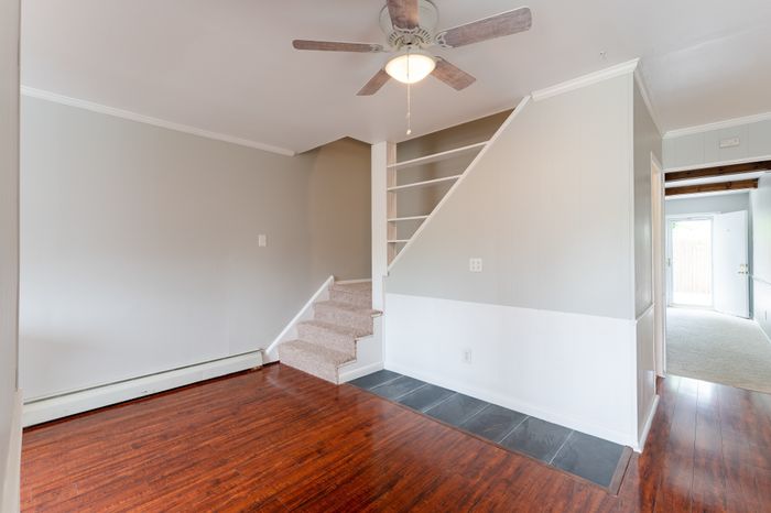 hardwood floor living room with staircase to second floor
