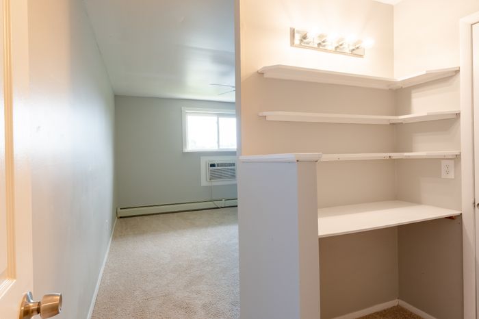 exposed bedroom shelves with vanity lights
