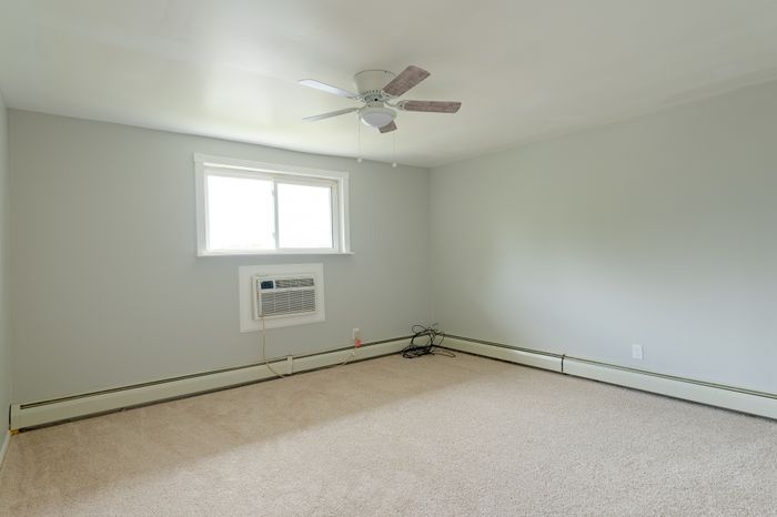 carpeted bedroom with window, ceiling fan, and A/C