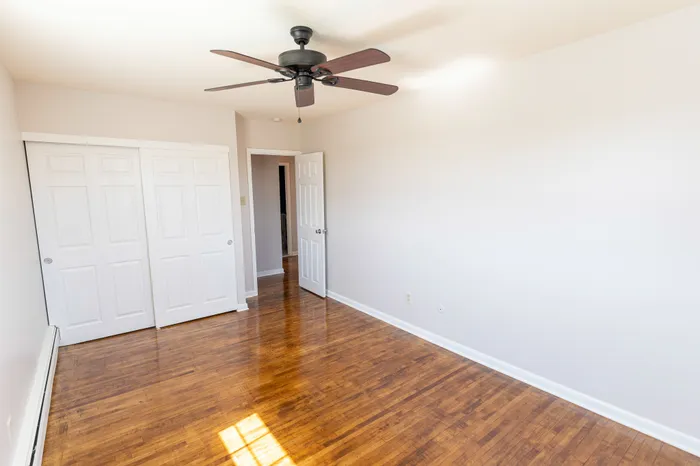 bedroom with wood floor and ceiling fan