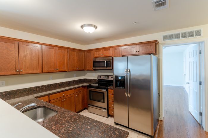 kitchen with modern appliances and lots of cabinet space facing bedroom