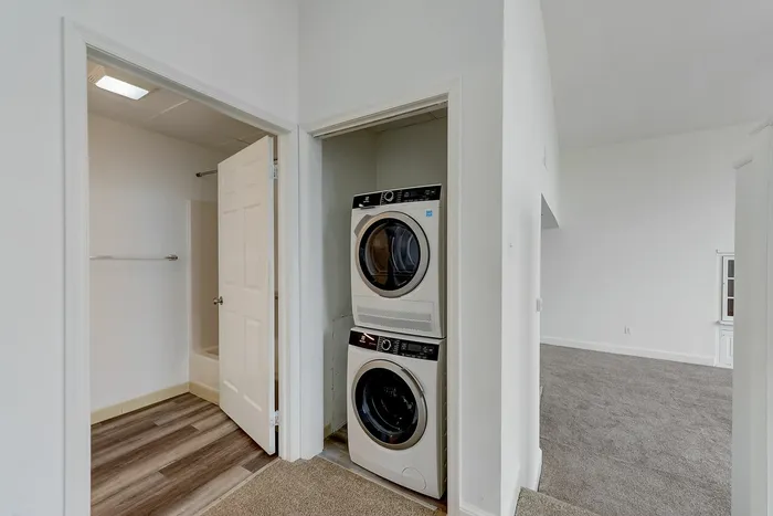 Stacked washer and dryer in hallway closet next to bathroom at Franklin Manor Apartments, West Reading PA.