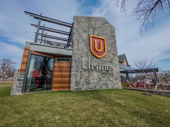 Stone Ursinus College sign and storefront near 405 at Main Apartments in Collegeville, PA.