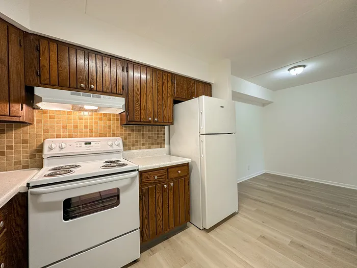 Charming kitchen with elegant wooden cabinetry, modern appliances, and a bright open space, perfect for culinary creativity.