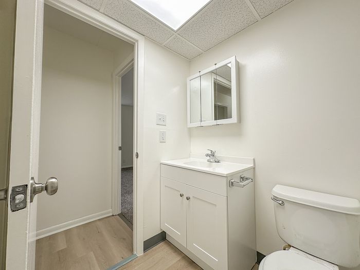 Bright and pristine bathroom with modern fixtures, featuring a sleek vanity, and ample natural light, creating an inviting and fresh atmosphere.