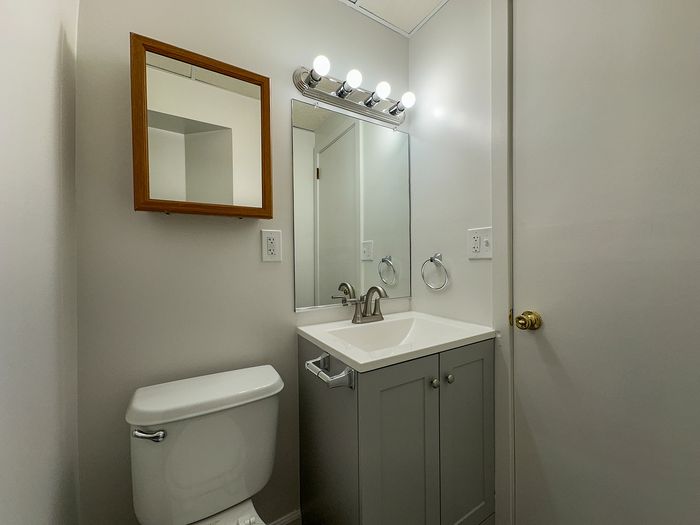 Modern bathroom with elegant vanity, sleek lighting, and contemporary fixtures creating a bright and refreshing space.