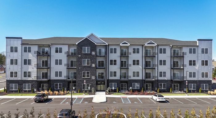 the warrington place apartments in warrington pa, 4 story luxury apartment building with lush landscaping