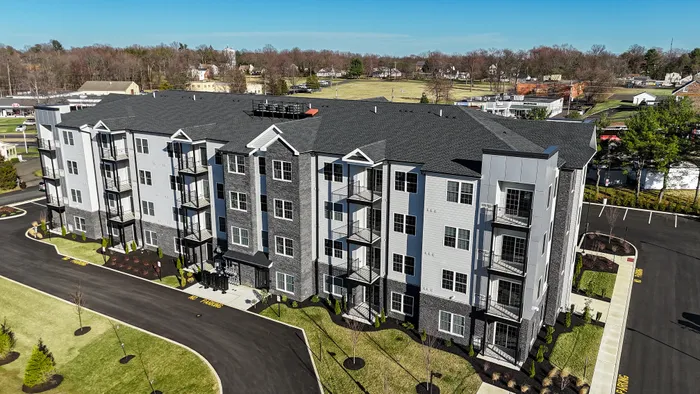 the warrington place apartments in warrington pa, 4 story luxury apartment building with lush landscaping