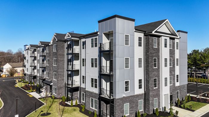 the warrington place apartments in warrington pa, 4 story luxury apartment building with lush landscaping
