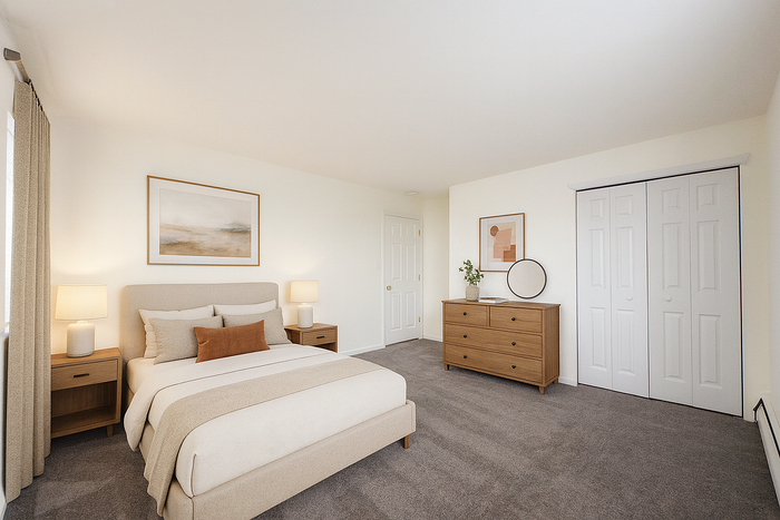 Furnished bedroom with queen bed, dresser and closet.