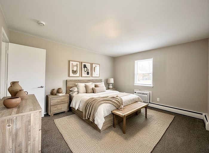 Inviting bedroom with a cozy bed, elegant decor, and soft natural light, creating a serene and stylish atmosphere.