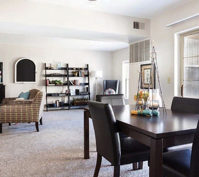 Inviting open-plan living and dining area with cozy seating, modern decor, and abundant natural light.