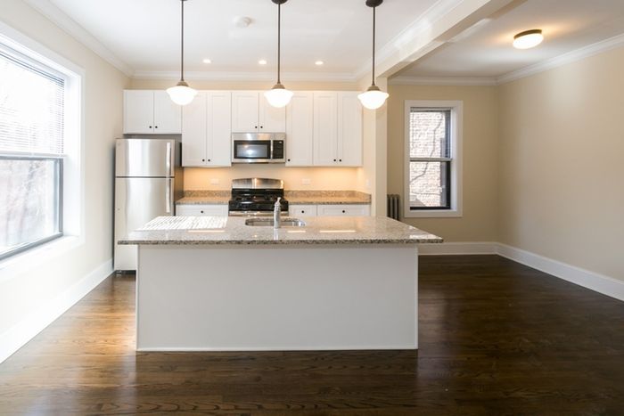 An upgraded kitchen with pendant lighting, dishwasher and built in microwave.