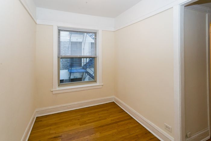 A separate dining area in a studio apartment with hardwood floors.