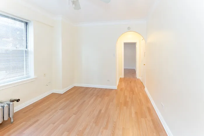 A nicely sized living room and vinyl wood flooring.