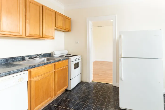 A functional kitchen with wood cabinets and a dishwasher.
