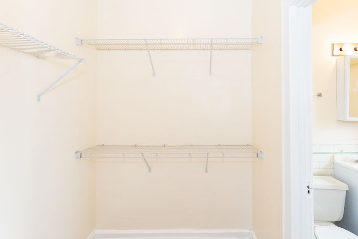 A big closet equipped with double hung wire hanging racks.