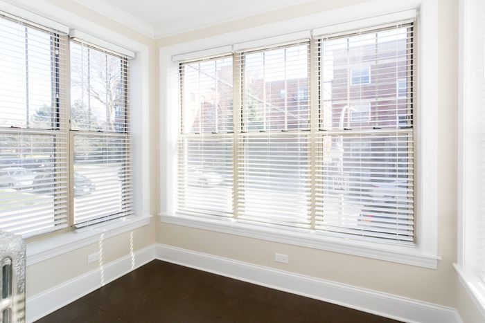 A bright and sunny sun room.  Can be used as a den or dining space.