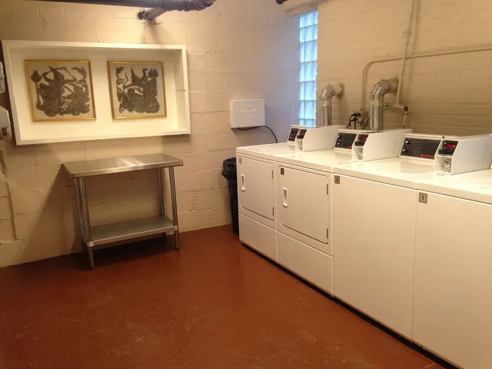 The on-site laundry room with coinless machines, and a folding table.