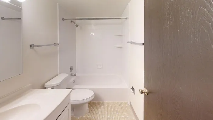 A bathroom with an extra large white vanity and a bathtub.