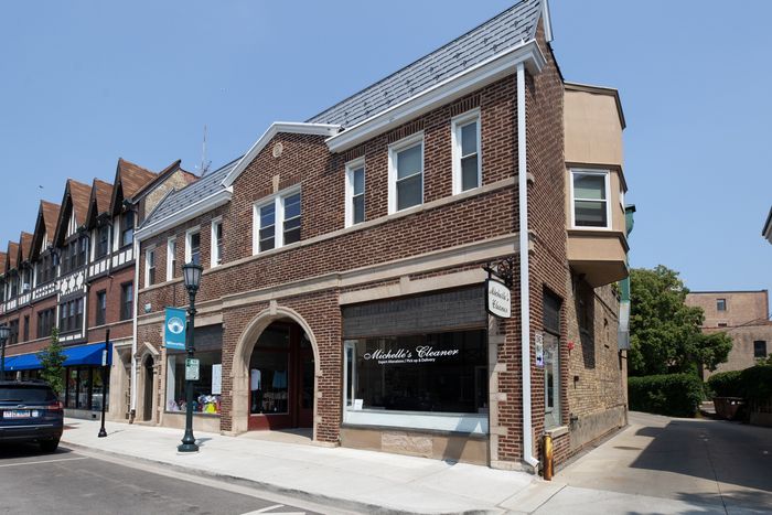 Exterior of 805-09 West Elm a four unit two story vintage red brick property with two storefronts in Winnetka.