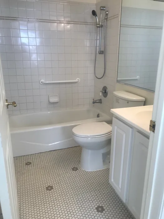Bathroom with white vanity and a bathtub.