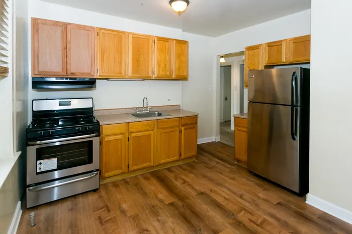 Kitchen with wood cabinets and stainless steel appliances.