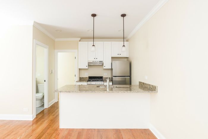 A junior one bedroom kitchen with stainless appliances, a dishwasher, and pendant lighting.