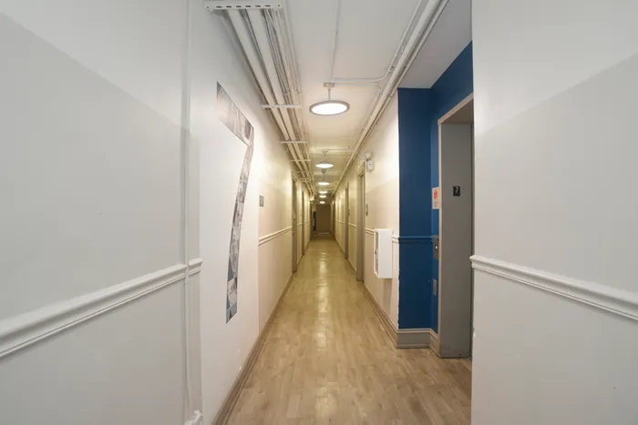 Hallway with blue accent wall and large 7 on opposite wall