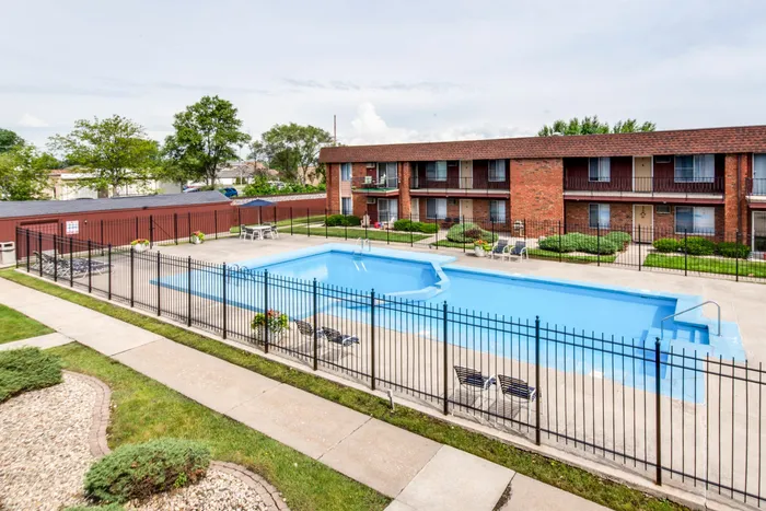 Two outdoor swimming pools with deck furniture for summertime use.