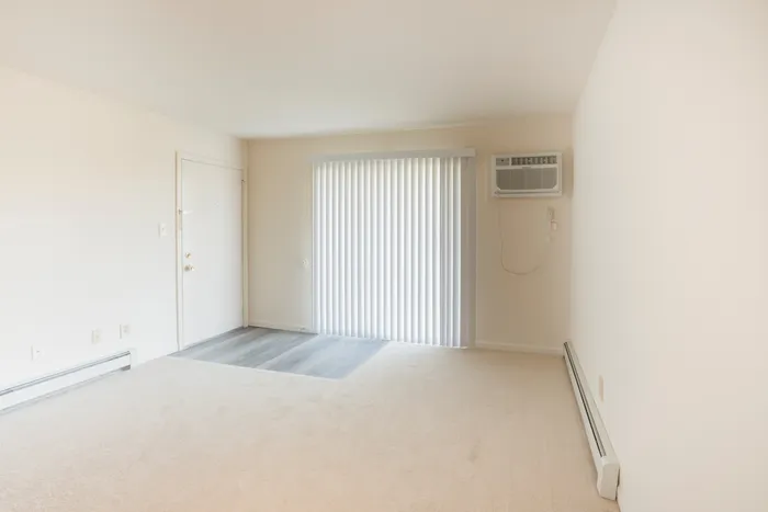 Living room with carpet and sliding glass door to balcony