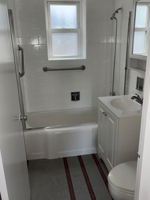 Bathroom with white tub and vanity