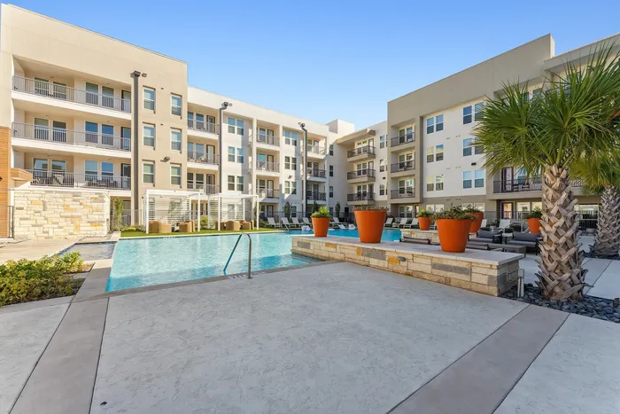 A beautiful high-end swimming pool with spacious walking areas at Latitude Apartments