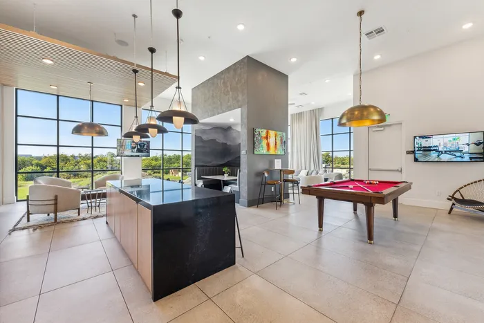 A stunning modern clubhouse with great views, sitting area, and billiards table at Latitude Apartments