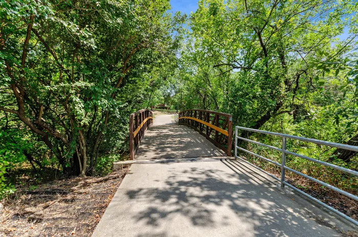Scenic walking path surrounded by lush greenery in Plano, TX.