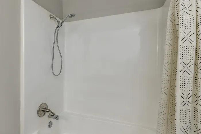 Stylish shower with rainfall showerhead and custom tilework at Riverside at Rockwater