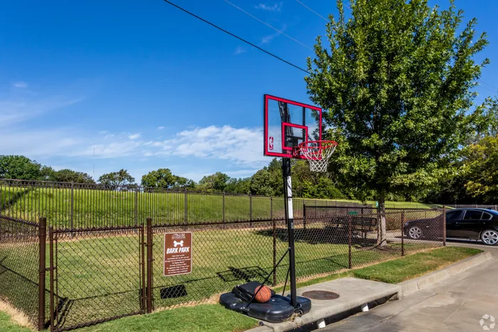 Outdoor basketball hoop with court area at Riverside at Rockwater, North Little Rock, AR