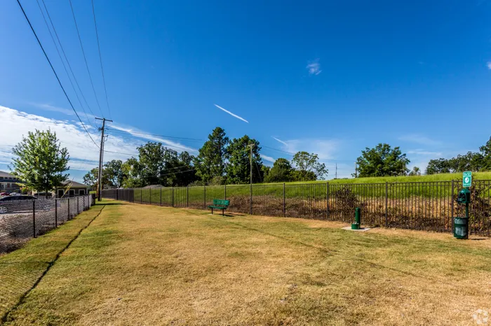 Expansive greenspace with lush grass and walking paths at Riverside at Rockwater, North Little Rock, AR