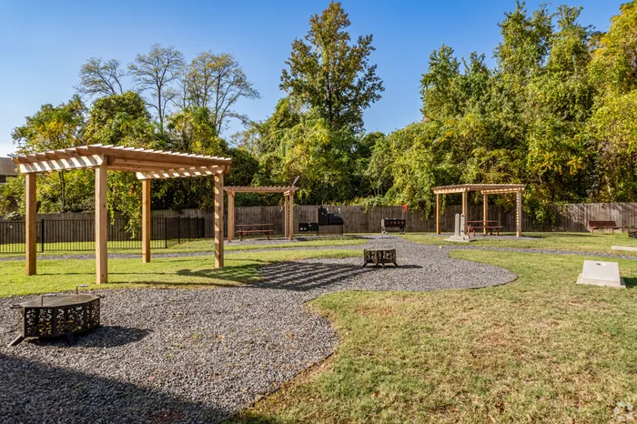 BBQ area with grills and communal seating at Riverside at Rockwater, North Little Rock, AR
