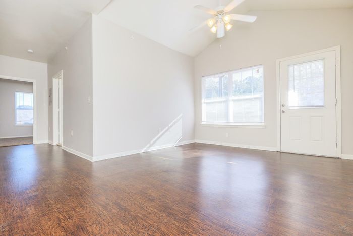 Spacious living room with modern furnishings at Southwest Pines Apartments in Tyler, TX